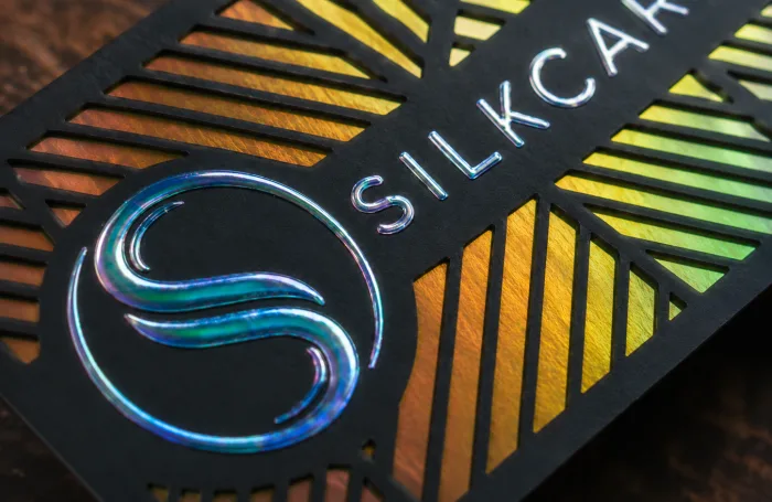 Black SilkCards card with holographic foil and gold foil showing through a die-cut pattern