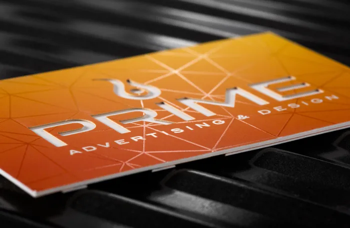 Orange 48pt silk card with glossy spot UV lettering and line work for Prime Advertising and Design