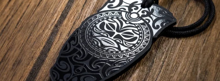 An onyx black suede card for Synergy Flight Center with navy blue, silver and teal foil detailing.