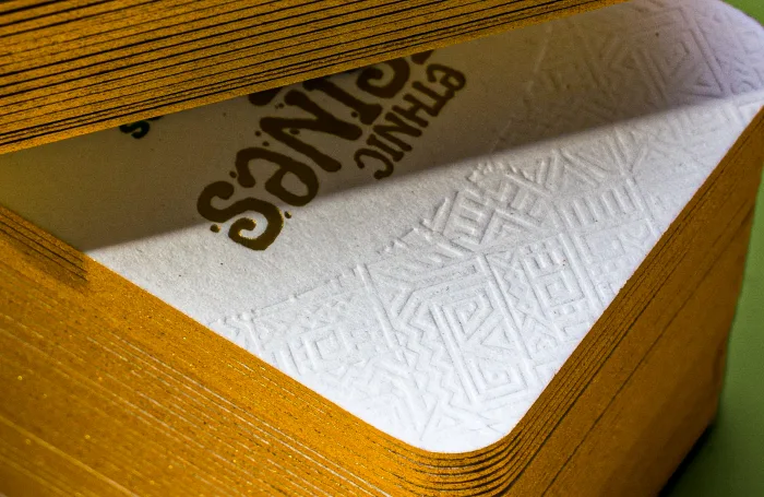 Cotton business card with multiple foil colors. Letterpress style debossing. Gold edges.