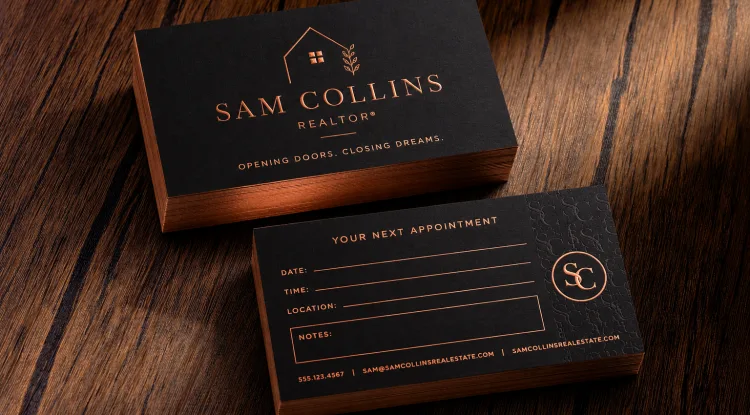 Black suede business cards with metallic copper foil text, logo, and copper edges.