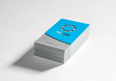 A SilkCards business card with raised foil lettering catching the light.