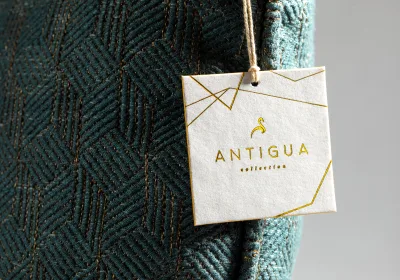 A premium hang tag on thick textured stock, tied with string.