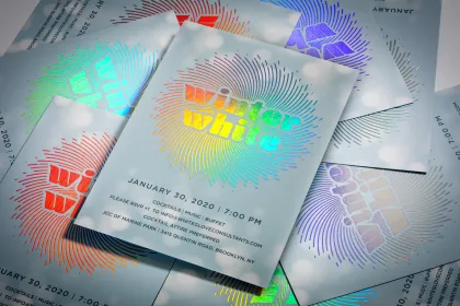 An oversized postcard with a soft-touch finish and a foil headline.