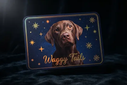 A dark holiday card featuring a dog and gold foil snowflakes.