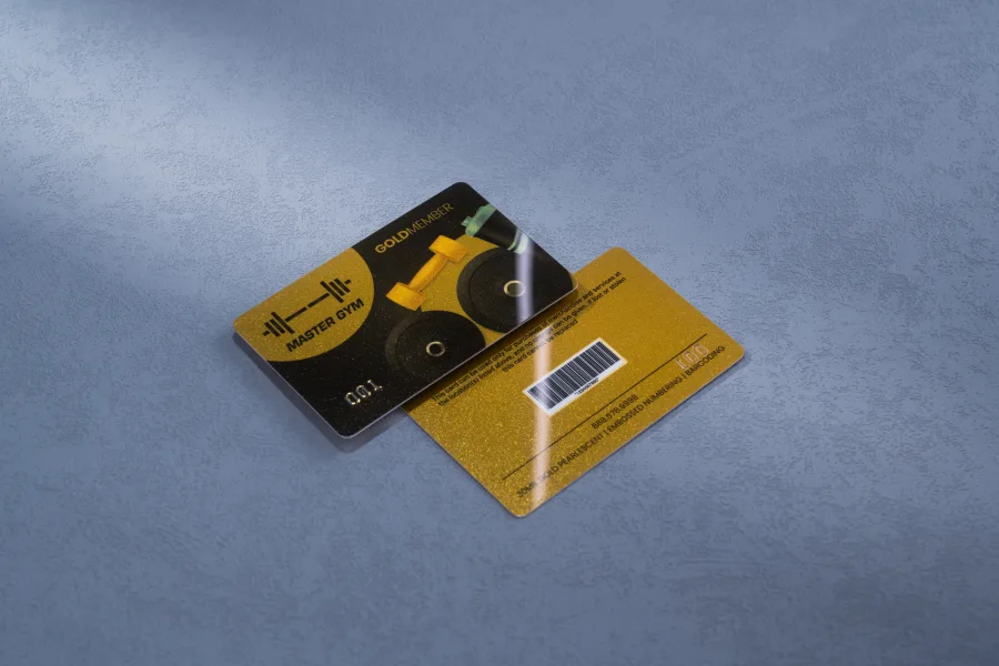 A black and gold Master Gym membership card with an embossed dumbbell graphic and a barcode on the back.